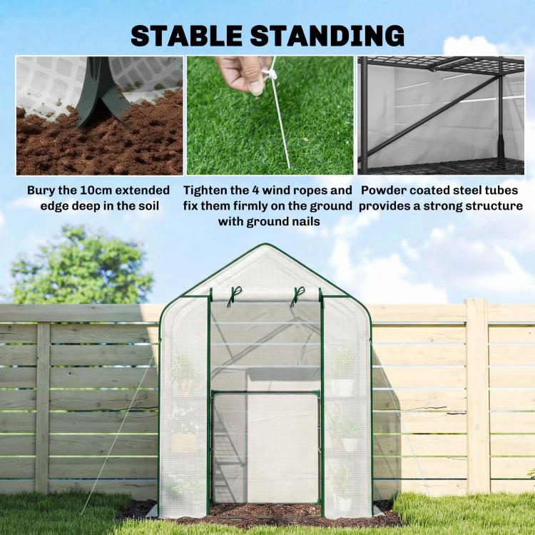 Portable greenhouse with green frame stabilized by ground stakes and guy ropes