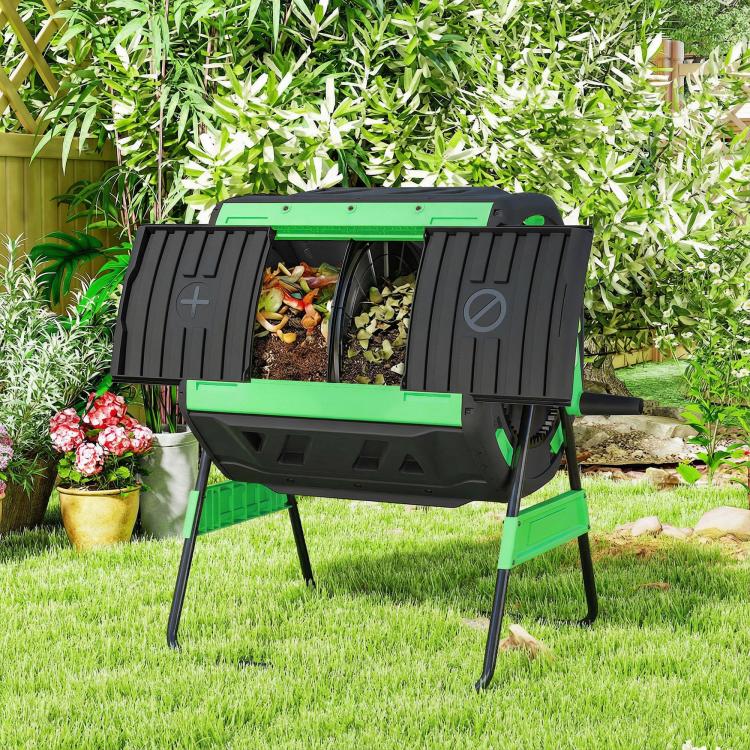 Outdoor dual-chamber tumbling compost bin on grass with open drum window