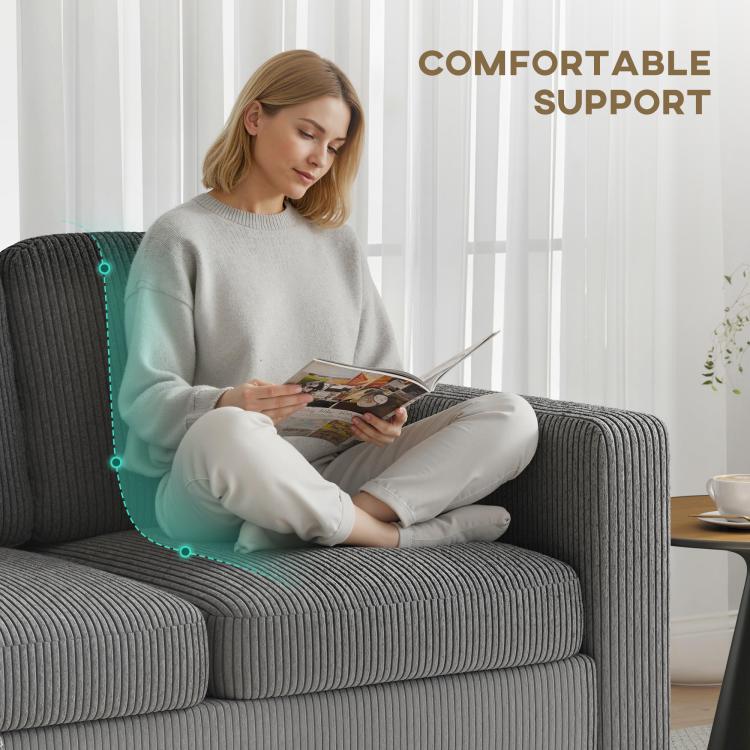 Dark gray sofa chaise with ribbed upholstery, shown with a person relaxing.