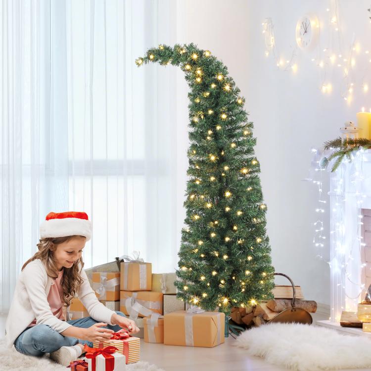 Prelit green Christmas tree with warm white lights on metal stand