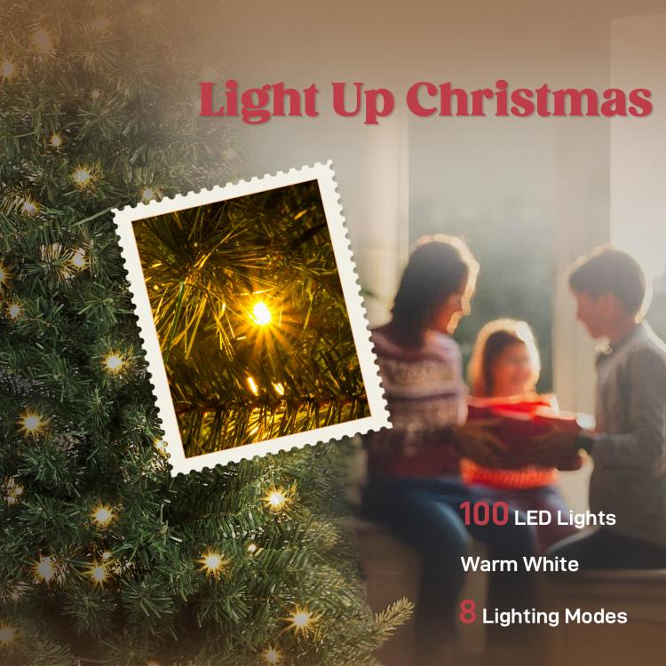 Warm white LED lights glowing on green Christmas tree branches