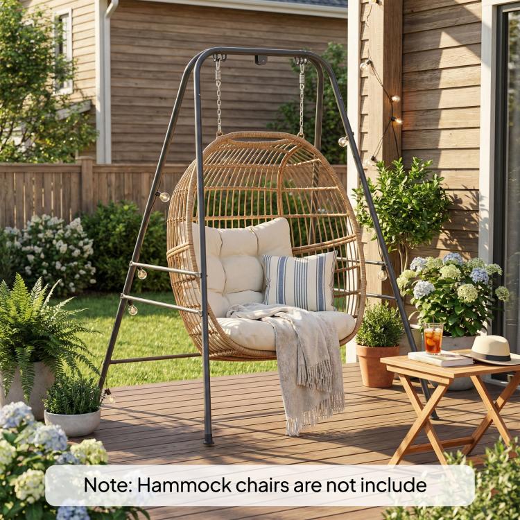 Gray hammock chair stand holding a round wicker hammock chair on patio