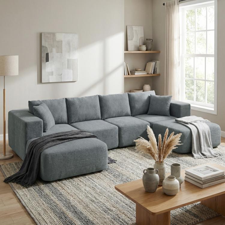 Dark gray modular sectional sofa with chaise lounge ottoman and multiple back cushions