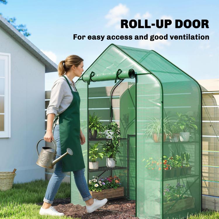 Green portable greenhouse with roll-up door and open front for easy access