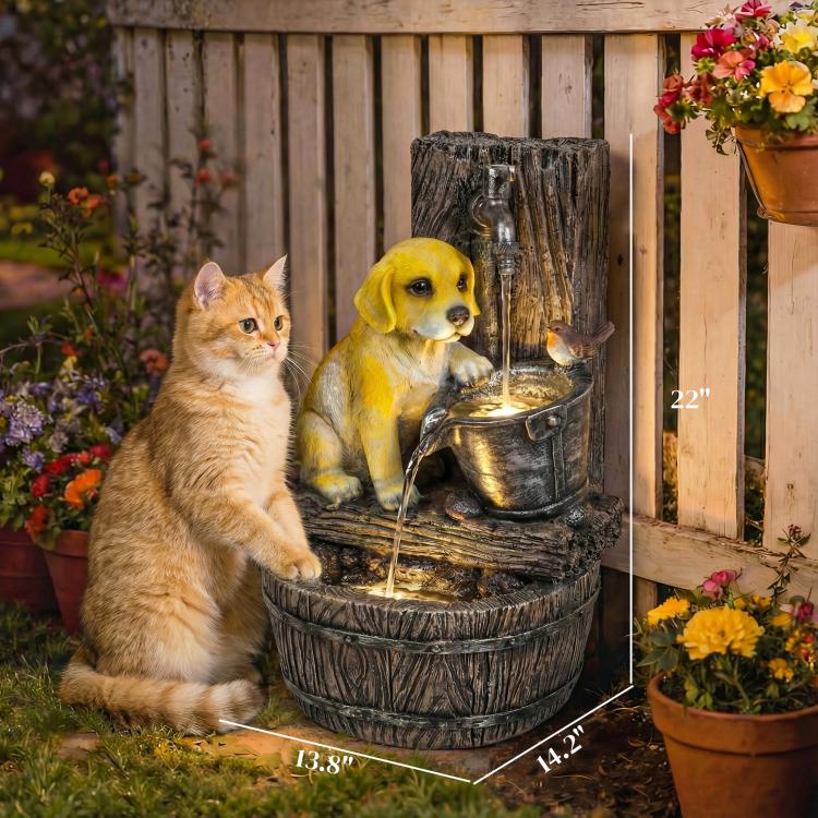 Three-tier dog fountain beside a cat statue, with a glowing water basin.
