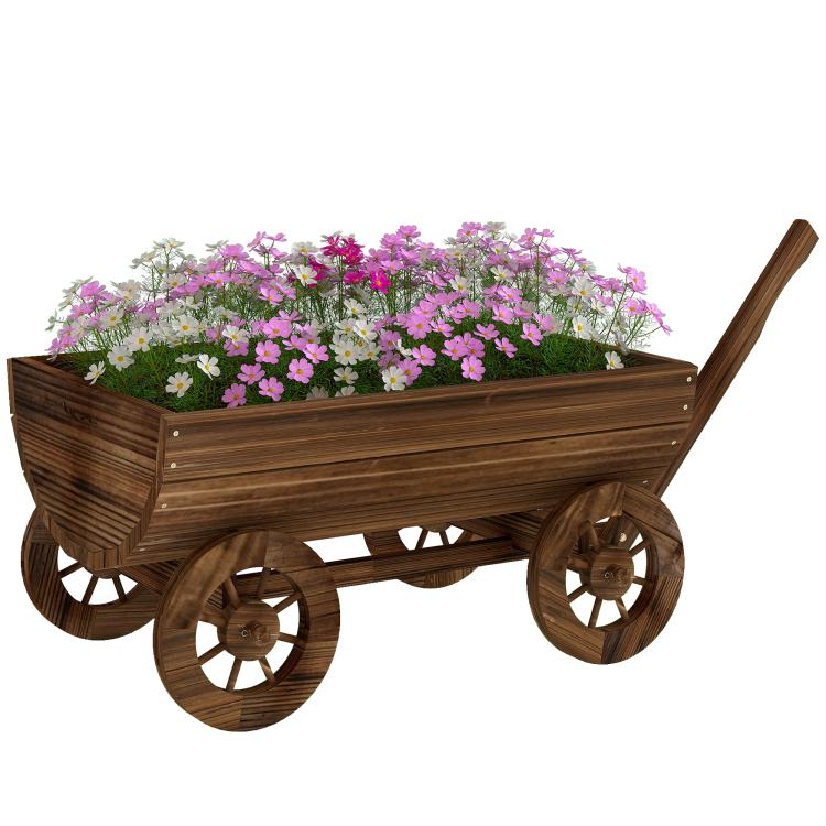 Wooden wagon planter box with four wheels, filled with pink and white flowers