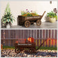 Wooden wagon planter cart with four wheels, filled with flowers and a long handle