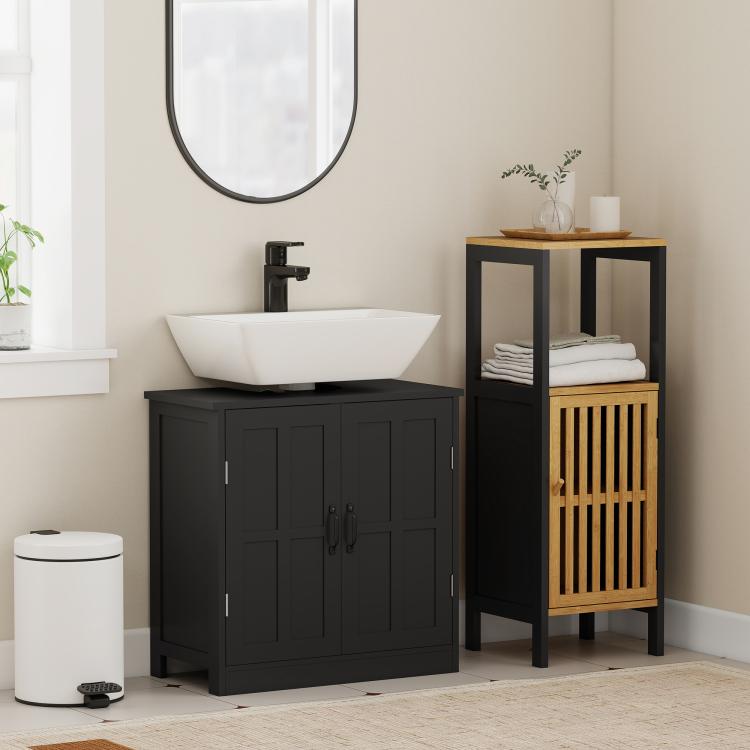 Black vanity sink cabinet with paneled doors and metal handles under a countertop sink
