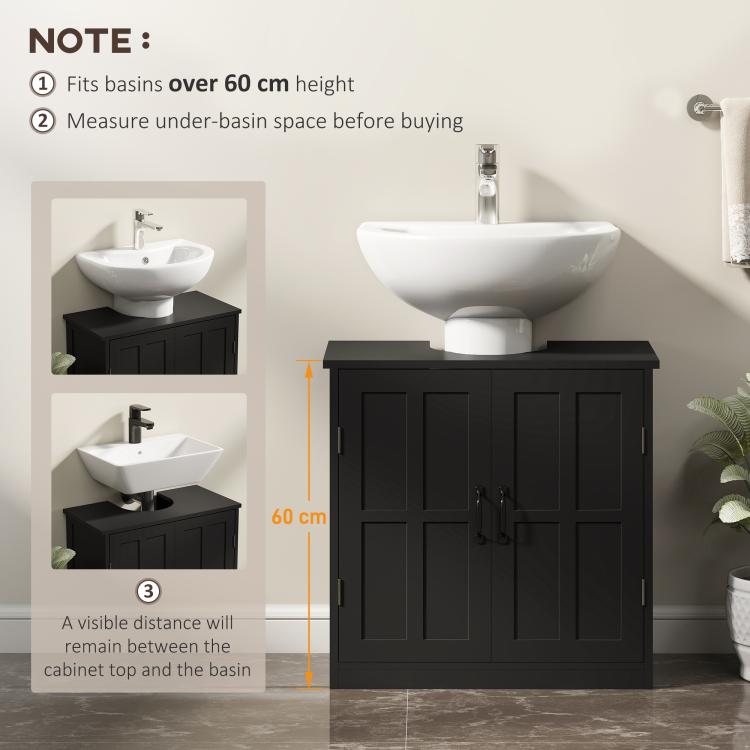 Black bathroom sink cabinet with paneled doors and metal handles with a sink on top