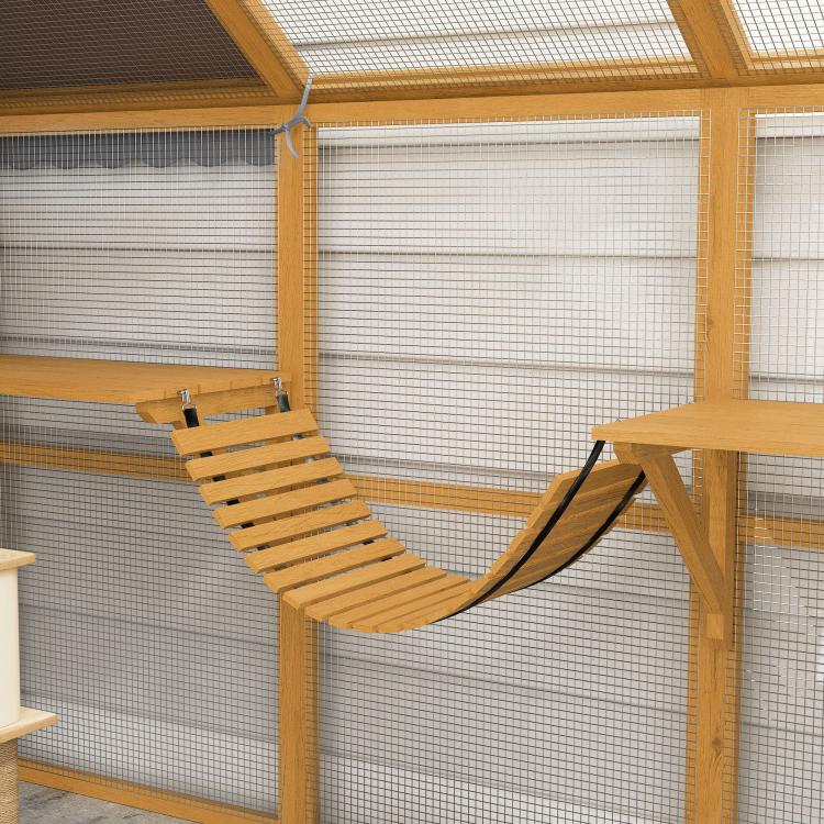Outdoor wooden cat enclosure with wire mesh walls, curved hammock platform between posts