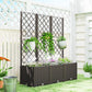 Raised planter bed with dark trellis and hanging planters beside home exterior