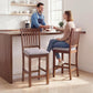 Two counter-height bar stools with dark brown frames, slatted high backs, gray padded seats