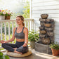 Rustic tiered jug fountain with cascading water and warm LED-lit cups