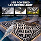 Black-and-white geometric outdoor rug with USB powered LED string lights