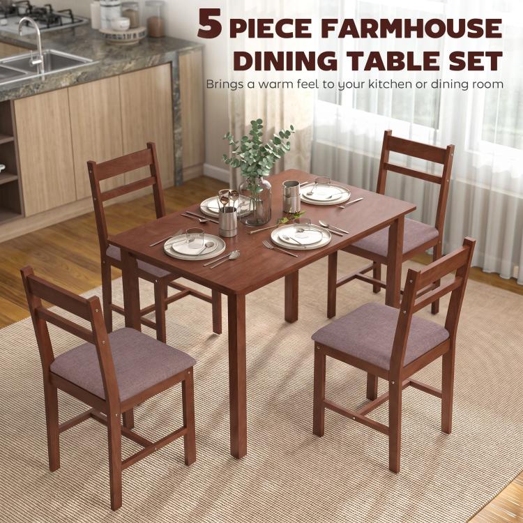 Light brown dining table set with four upholstered chairs in a kitchen setting