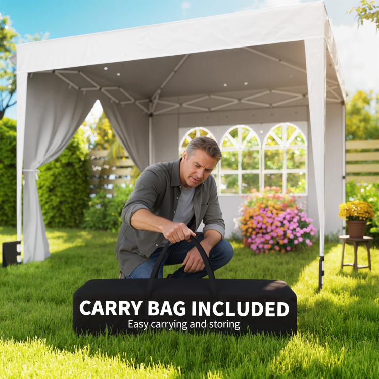 White pop-up canopy tent with sidewalls and included black carry bag on grass