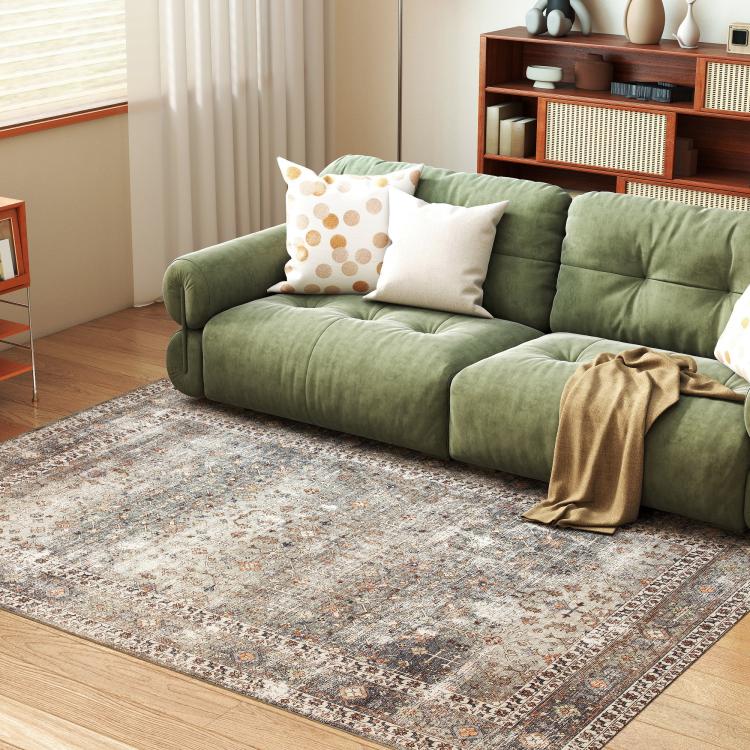 Traditional area rug with distressed gray and tan motif pattern, rectangular on wood floor