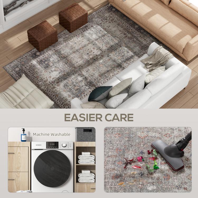 Traditional area rug corner with distressed gray and rust-brown motifs, close-up view