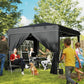 Black outdoor canopy tent with attached side panels and window panels over grass