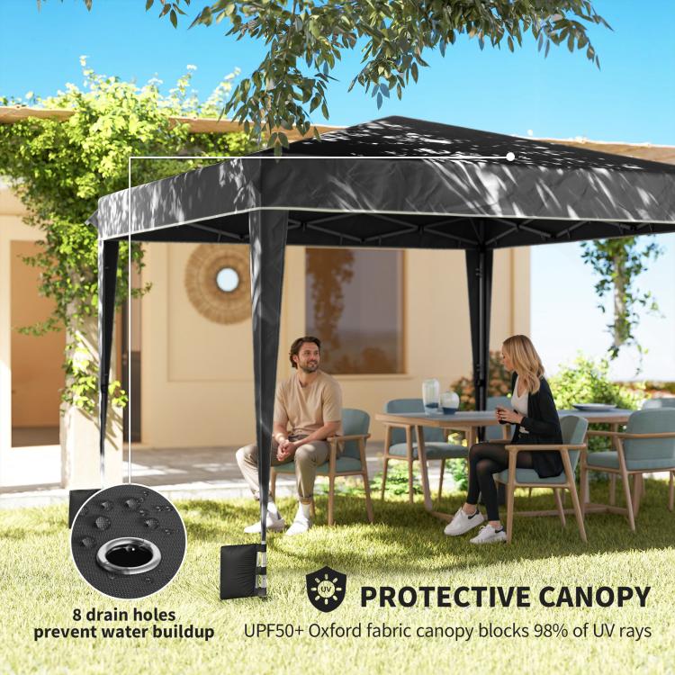 Black canopy tent shelter with protective canopy over outdoor patio seating area