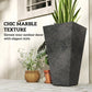 Single tall black marble-texture plastic planter with green plant and nearby flowers