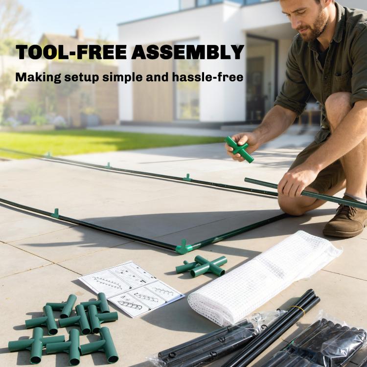 Mini greenhouse parts laid out for assembly on a patio surface