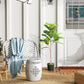 Artificial fiddle-leaf fig tree with green leaves in dark round pot, tall trunk