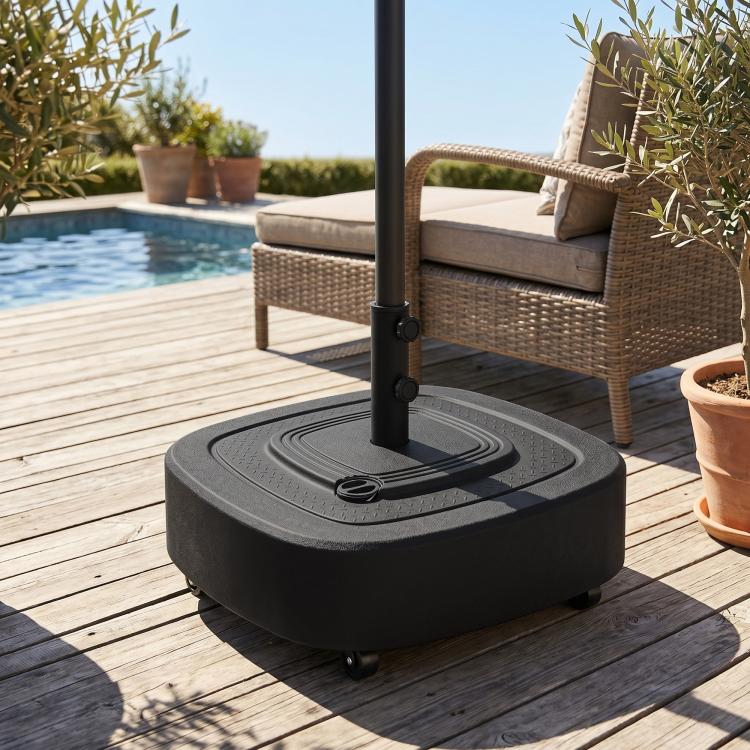 Black umbrella base stand with wheels and pole mount on wooden deck