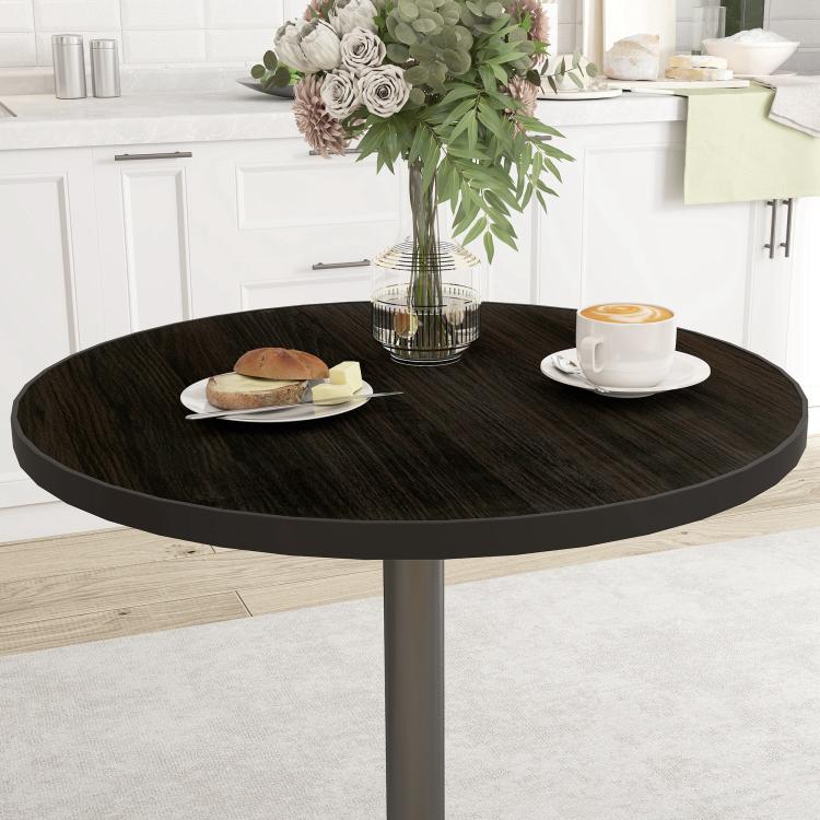 Round dining table with dark wood-grain top and black pedestal base