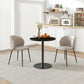 Round black wood-grain kitchen dining table with pedestal base in bright room