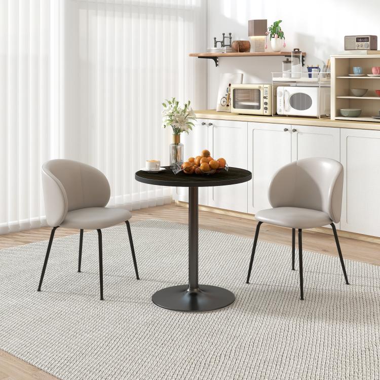Round black wood-grain kitchen dining table with pedestal base in bright room