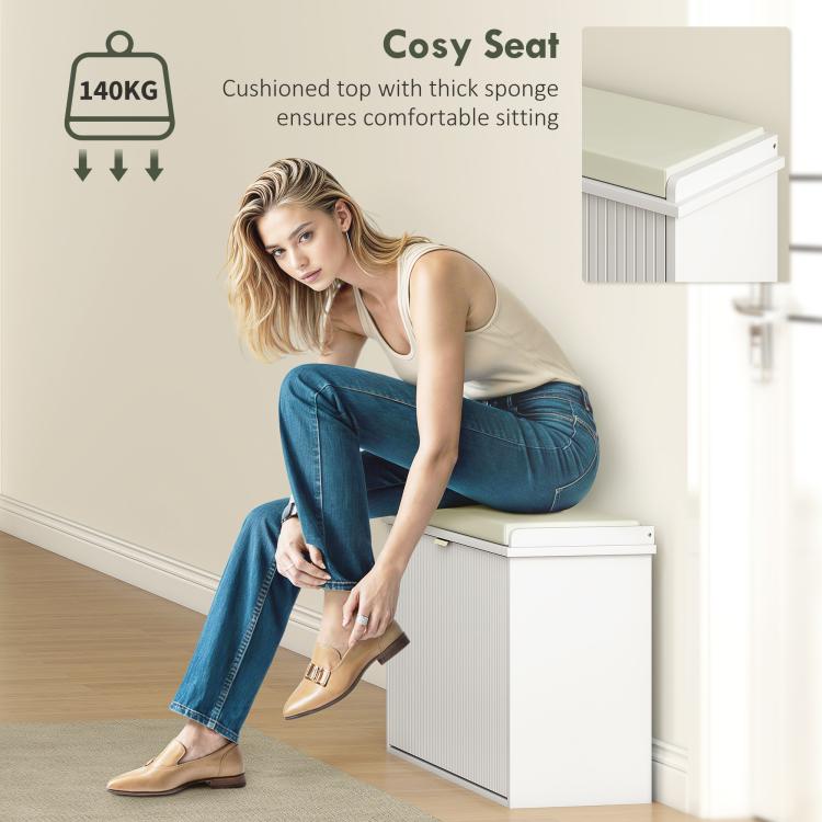 White shoe storage bench with thick padded seat cushion, shown seated for comfort
