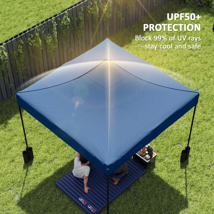 Navy replacement pop-up canopy cover with four weight bags on the grass