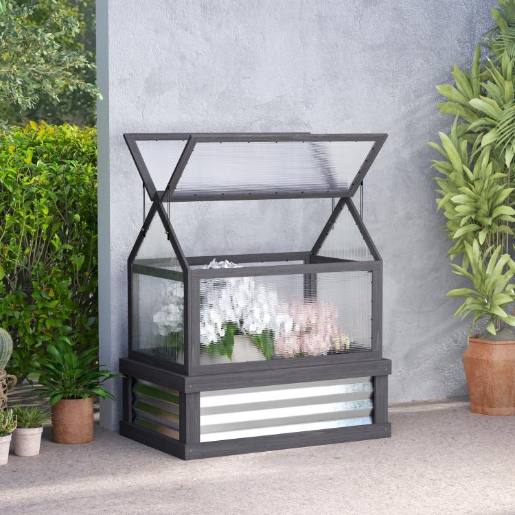 Gray wooden greenhouse cold frame planter with clear panels on outdoor patio