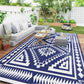 Navy and white geometric outdoor rug under patio seating