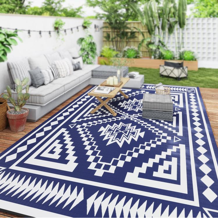 Navy and white geometric outdoor rug under patio seating