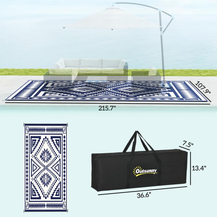 Blue and white outdoor rug with black carry bag shown for size
