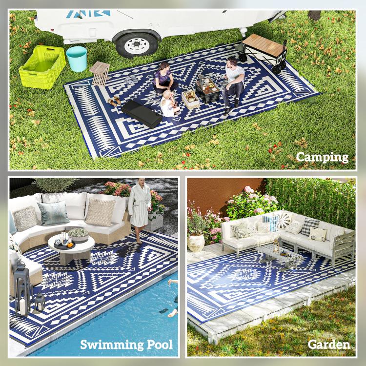 Blue and white camping rug with geometric pattern on grass