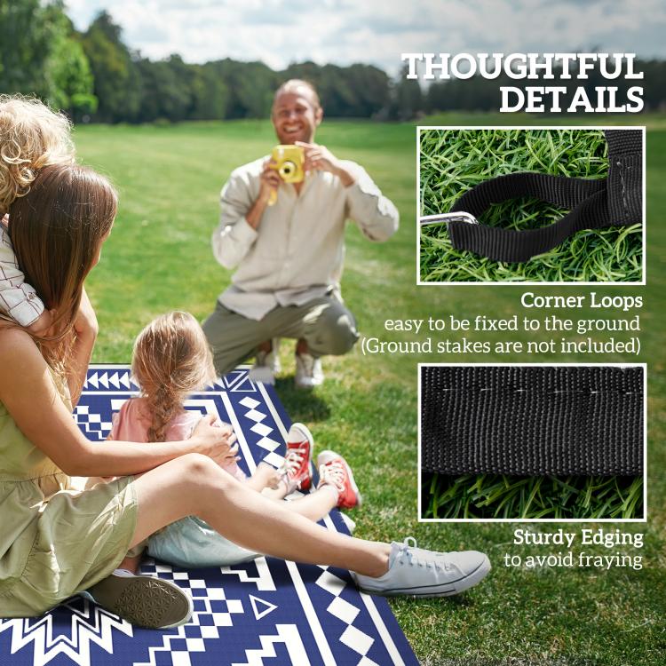 Outdoor rug with navy and white pattern and corner loops for stakes