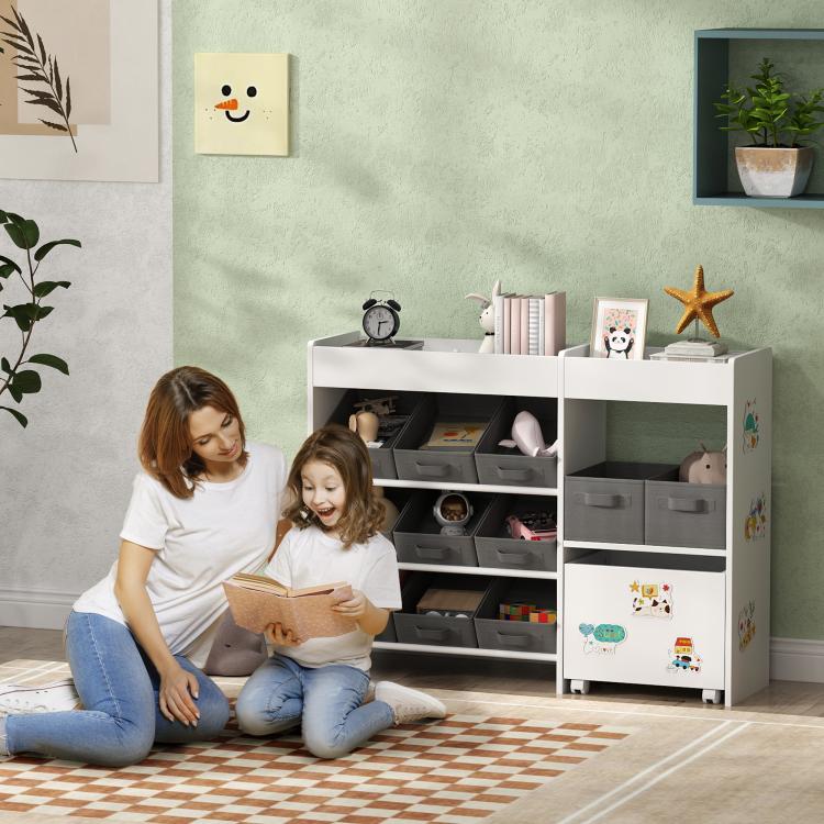 White toy storage organizer cabinet with gray bins, top shelves, and space for toys