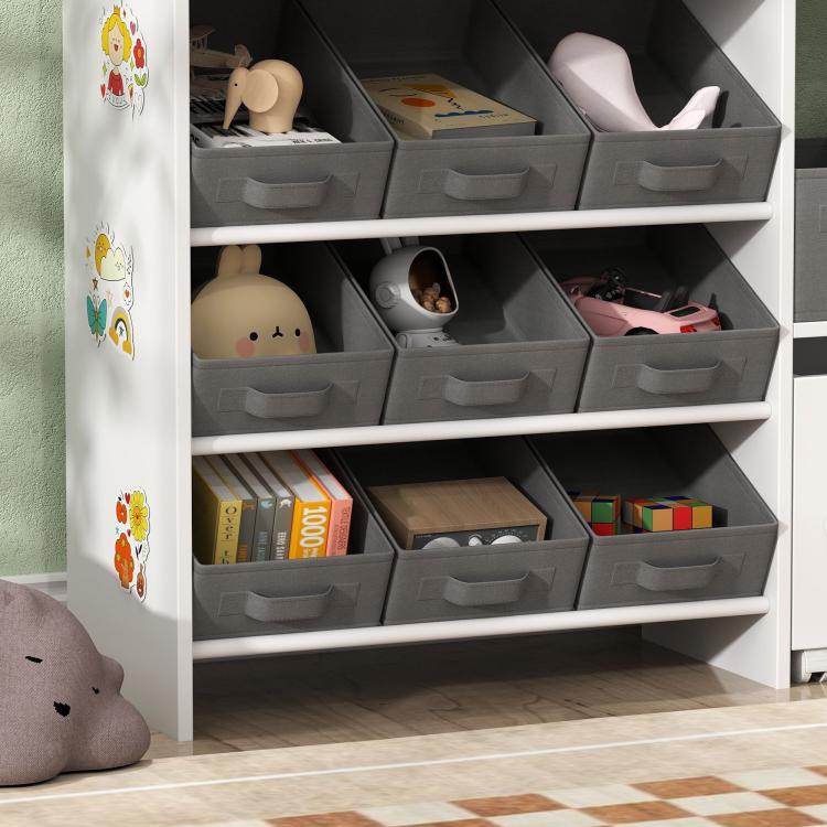 Close view of white organizer cabinet with gray fabric bins holding toys and books