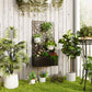 Wall-mounted black metal planter with trellis and planted flowers