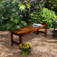 Backless outdoor wood bench with slatted seat and armrests, dark brown