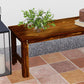 Corner view of backless wood garden bench with slatted top, dark brown finish