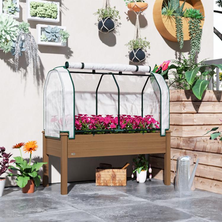 Raised garden bed with mesh greenhouse cover, brown frame, pink flowers inside