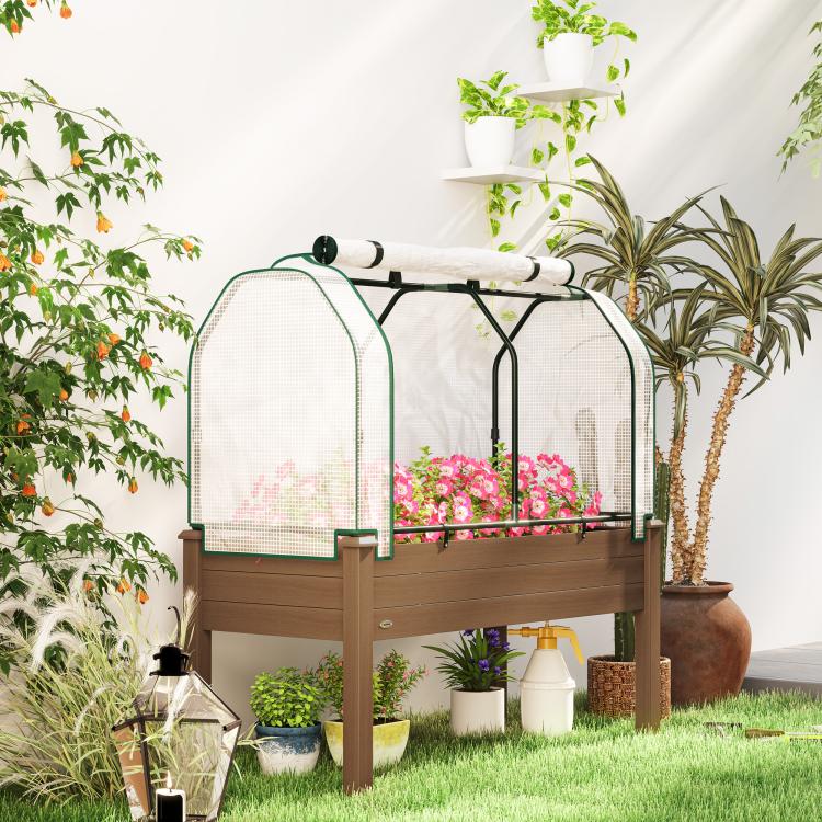 Raised garden bed with greenhouse cover, brown frame, pink flowers inside mesh