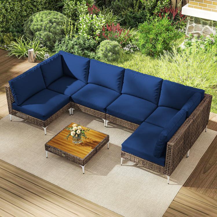 Modular outdoor sectional sofa set with blue cushions and woven wicker base plus coffee table