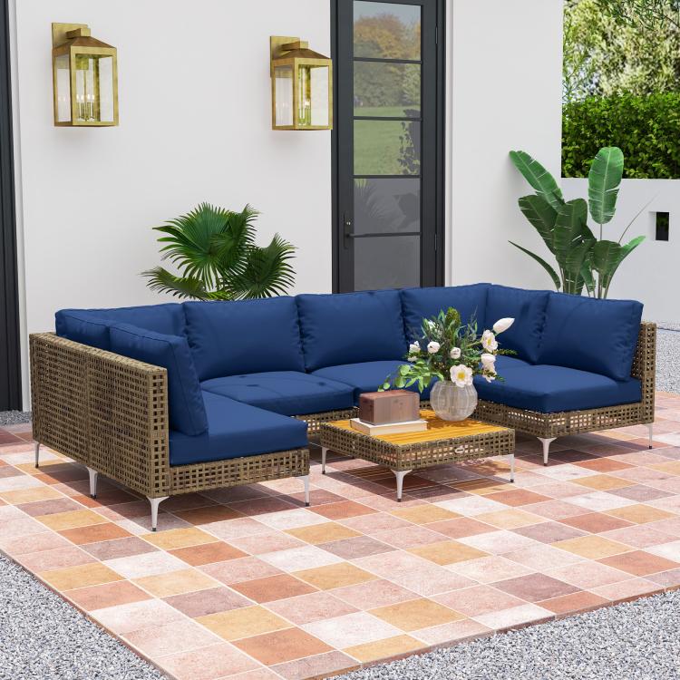 Outdoor sectional sofa with blue cushions, woven sides, and acacia-style wood coffee table