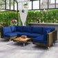 Woven wicker outdoor sectional with blue cushions and matching square coffee table