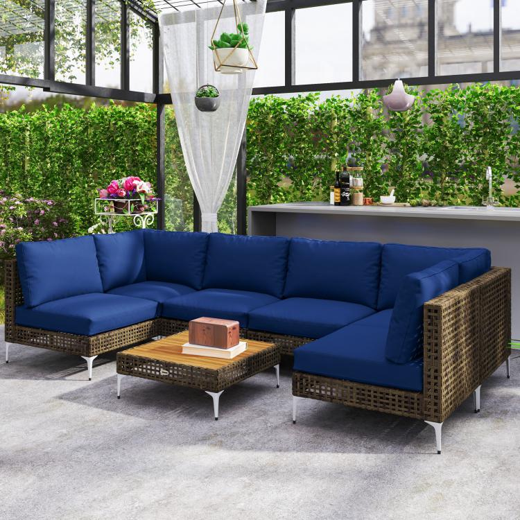 Woven wicker outdoor sectional with blue cushions and matching square coffee table